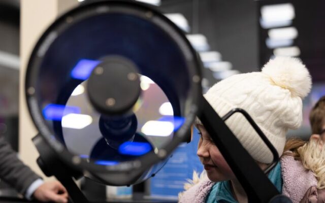 Child looking through telescope