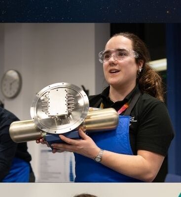 A poster of the night sky with large blue and yellow font that says Hands-on family fun! There is a picture of the event speakers and some of the equipment they work on.